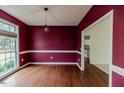 Elegant dining room featuring hardwood floors, modern lighting, and large windows at 1000 W Landing Dr, Sanford, NC 27330