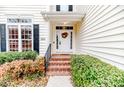 Inviting front door with a decorative wreath and well-manicured landscaping at 1000 W Landing Dr, Sanford, NC 27330