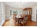 Formal dining room with hardwood floors, a chandelier, and built-in hutch at 102 Wightman Ct, Cary, NC 27511