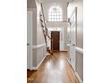 Elegant entryway with hardwood floors, a grand staircase and a large window at 102 Wightman Ct, Cary, NC 27511