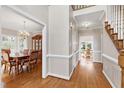 Bright and spacious entryway with hardwood floors and views to the dining room and backyard at 102 Wightman Ct, Cary, NC 27511