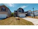 Charming two-story home featuring stone accents, a two-car garage, and a well-manicured front lawn at 120 Anise Tree Way, Clayton, NC 27527