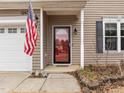 Close-up of the front door with an American flag and clean entryway at 12420 Tetons Ct, Durham, NC 27703