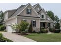 View of the house showing driveway and the beautiful, landscaped front yard at 1509 Yardley Dr, Wake Forest, NC 27587