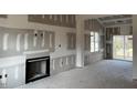 Spacious living room with a fireplace and sliding glass doors at 17 Golden View Pl, Zebulon, NC 27597