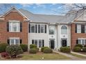 Two-story brick and siding townhouse with a charming front porch at 203 Anniston Ct, Cary, NC 27519