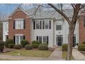 Two-story brick and siding townhouse with a charming front porch at 203 Anniston Ct, Cary, NC 27519