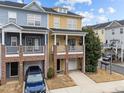 Two-story townhome with brick and siding exterior, attached garage, and front yard at 220 Broadgait Brae Rd, Cary, NC 27519