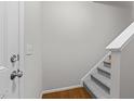 Interior view of a carpeted staircase and hallway with hardwood floors at 220 Broadgait Brae Rd, Cary, NC 27519