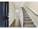 Inviting entryway with hardwood floors and carpeted staircase at 245 E Webber Ln, Clayton, NC 27527
