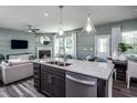 Modern kitchen island with granite countertops and stainless steel appliances at 2919 Huxley Way, Apex, NC 27502