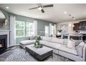 Spacious living room with sectional sofa and fireplace at 2919 Huxley Way, Apex, NC 27502