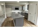 Modern kitchen with gray cabinets, granite countertops, and an island at 395 Magnolia Run Way, Benson, NC 27504