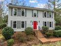Two story house with gray siding, red door, and brick walkway at 4532 Malvern Rd, Durham, NC 27707