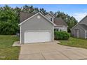 Attractive home exterior with a two-car garage, concrete driveway, and well-maintained front yard at 5110 Chipstone Dr, Raleigh, NC 27610
