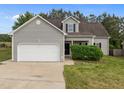 Inviting home showcasing gray siding, black shutters, and a two-car garage, with manicured front yard at 5110 Chipstone Dr, Raleigh, NC 27610
