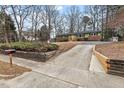 Street view of a single-story home with a brick foundation, driveway, and landscaped yard at 5232 Guess Rd, Durham, NC 27712