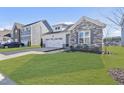 A beautifully designed home with a stone facade, spacious lawn, and a convenient two-car garage at 612 Sweet Pine Ln, Knightdale, NC 27545