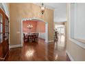 Elegant foyer with hardwood floors, archway into dining room, and a view of the staircase leading to the upper level at 10014 Hammock Bend Bnd, Chapel Hill, NC 27517