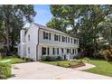 Charming two-story home with a manicured lawn and a spacious driveway at 106 N Trail Dr, Raleigh, NC 27615