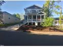 Inviting two-story home featuring a charming front porch and freshly landscaped yard at 107 Bond St, Durham, NC 27707