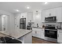 Modern kitchen with white cabinetry, stainless steel appliances, and a stylish island at 130 S Estes Dr # G3, Chapel Hill, NC 27514