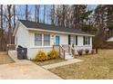 Inviting one-story home with white siding, blue door, and tidy front yard at 200 Westbury Dr, Oxford, NC 27565