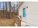 Side entrance with a white door and wood railing at 200 Westbury Dr, Oxford, NC 27565