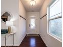 Bright foyer with hardwood floors, white walls, coat racks, and a decorative mirror at 2027 October Dr, Durham, NC 27703