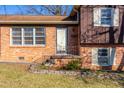 Close-up of the front entrance showcasing the brick facade, small porch, and neat landscaping at 206 Eastway Ln, Graham, NC 27253