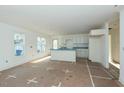 Bright, open-concept kitchen featuring white cabinets, a center island and plenty of natural light from two windows at 2481 Michelle Dr, Burlington, NC 27217