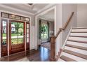 Inviting foyer showcasing hardwood floors, staircase and view into the living room at 318 Ivy Ridge Rd, Chapel Hill, NC 27516