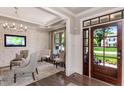 Elegant living room featuring modern chandelier, accent wall and hardwood flooring at 318 Ivy Ridge Rd, Chapel Hill, NC 27516