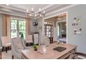 Comfortable home office featuring a chandelier, large desk and plenty of natural light at 318 Ivy Ridge Rd, Chapel Hill, NC 27516