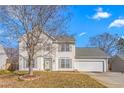 Charming two-story home with classic vinyl siding, mature trees, and two-car garage at 2506 Pepperstone Dr, Graham, NC 27253