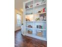 Bright living room featuring beautiful built-in shelving and luxury vinyl plank flooring at 256 Wembley Dr, Clayton, NC 27527