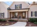 Inviting front porch with brick columns and seating, creating a welcoming entrance to the home at 2941 Mt Vernon Church Rd, Raleigh, NC 27613