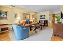 Inviting living room featuring neutral carpet, soft yellow walls, decorative artwork and comfortable seating at 3929 Browning Pl, Raleigh, NC 27609