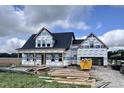 A new two-story house with dark roof under construction on a sunny day with an attached two-car garage at 3943 Baileys Xrds Rd, Benson, NC 27504