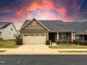 Attractive home with a stone-accented facade, inviting two-car garage, and well-kept lawn at 3947 Foxglove Trl, Burlington, NC 27215