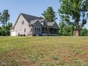 View of the back of home with a screened-in porch and a 2-car attached garage at 3958 Buckhorn Rd, Sanford, NC 27330