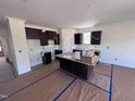 Spacious kitchen area with dark cabinets, an island, and natural light at 3963 Baileys Xrds Rd, Benson, NC 27504