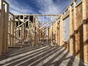 Interior framing view showcasing the construction of walls, windows and open floor plan at 47 Royal Ave, Selma, NC 27576