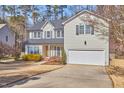 Charming two-story home with attached two-car garage and well-manicured front yard at 5460 Ingate Way, Raleigh, NC 27613