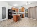 Bright kitchen features an island with granite countertops, stainless appliances, and a pantry at 5841 Wynmore Rd, Raleigh, NC 27610