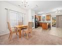 Open kitchen with an island, stainless steel appliances, and an adjacent dining area at 5841 Wynmore Rd, Raleigh, NC 27610