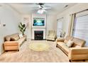 Cozy living room featuring a fireplace, neutral color palette, and comfortable sofas at 5841 Wynmore Rd, Raleigh, NC 27610