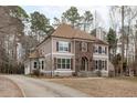 Beautifully landscaped home with a long driveway, mature trees, and a well-maintained lawn at 6016 Heatherstone Dr, Raleigh, NC 27606