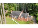 An elevated view of a brick home showing landscaping, mature trees, and a well-maintained lawn at 612 W Chisholm St, Sanford, NC 27330