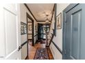 Inviting entryway featuring hardwood floors, a staircase, and views into other rooms at 612 W Chisholm St, Sanford, NC 27330